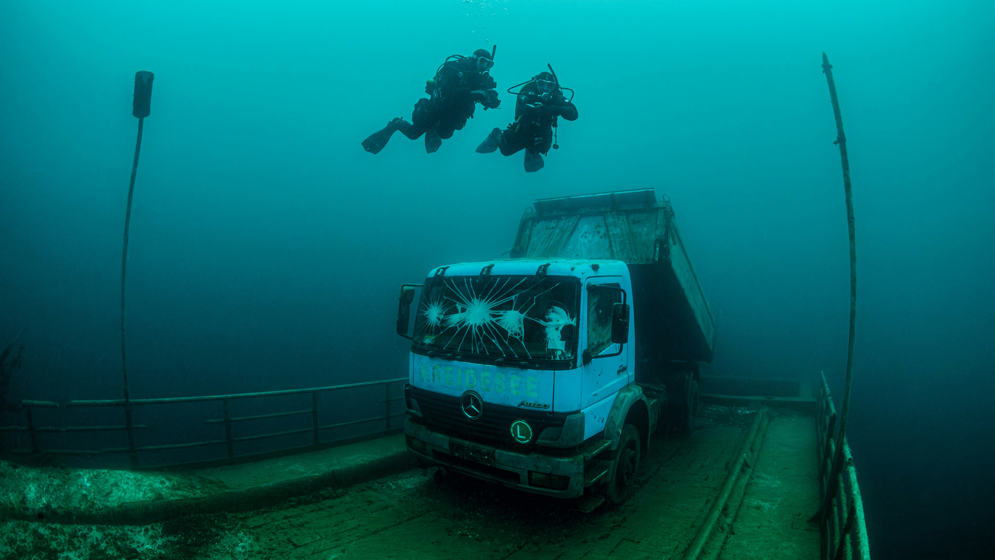 gift-of-exploration.png Divers discovering a truck wreck.