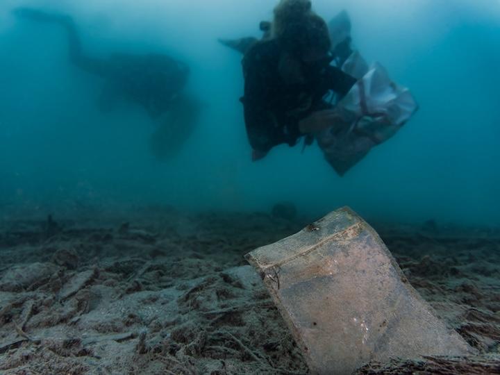 Two divers cleaning up the ocean.