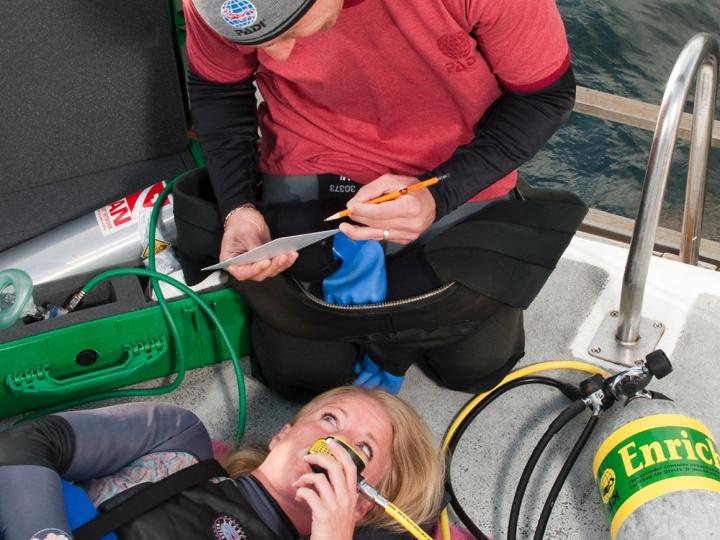 Person practicing giving emergency oxygen.