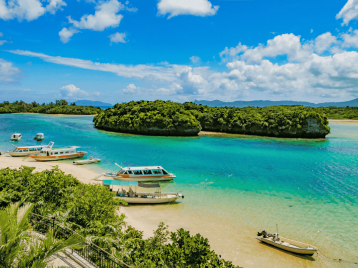 Scenic view of Kabira Bay in Ishigaki Island with turquoise waters, white sand, and lush green islets.