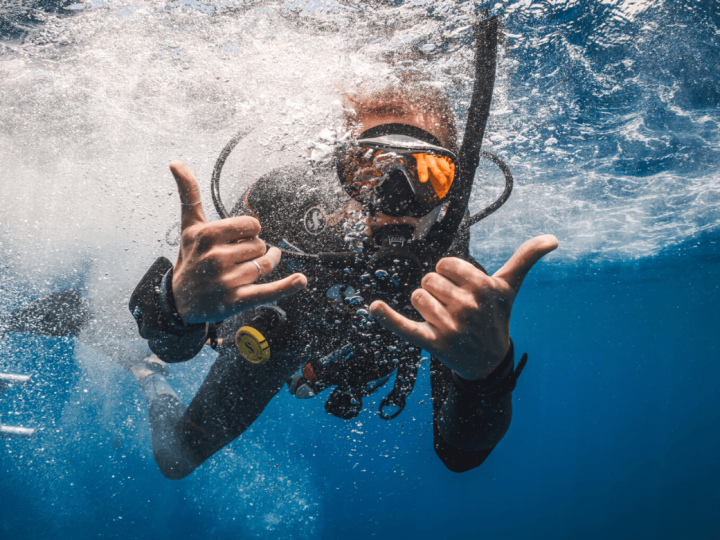 Diver giving a shaka hand sign.