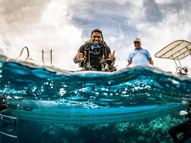 Person giving thumbs up at sea level
