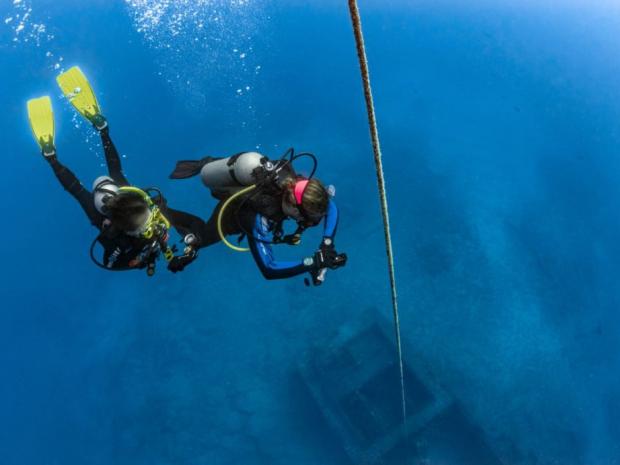 Two divers ready to go discover a sea wreck.