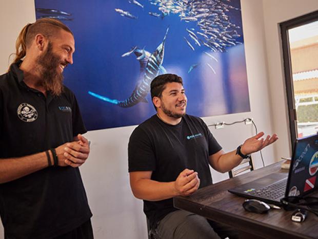 Two people looking at a computer