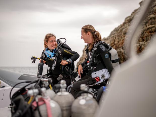 two female divers on a boat