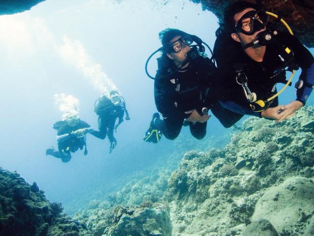 Divers going into a cavern