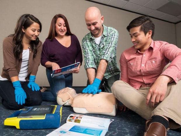A group of people learning CPR.